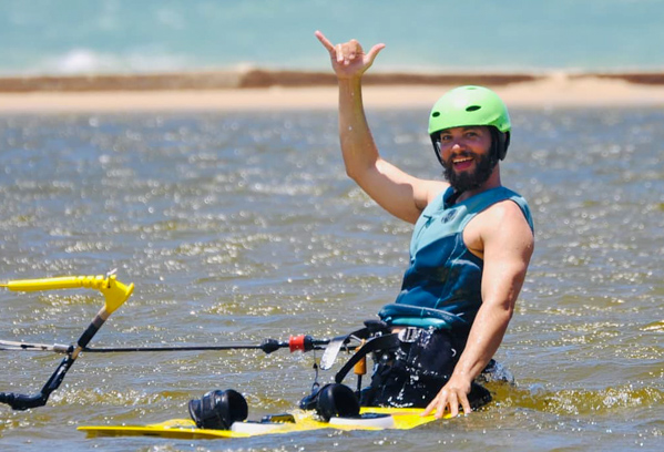 A rider on the lagoon throwing a rock-on sign to the camera